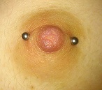 Female, horizontal nipple piercing with incorrect placement, wrong sized jewelry.