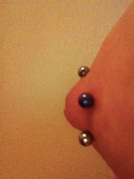 Double Nipple Piercing (Iron Cross) Side View