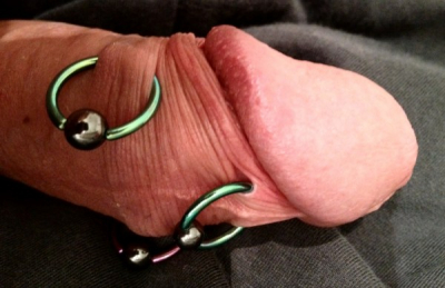 Foreskin piercings with niobium rings, tissue retracted