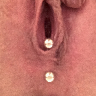 A fourchette piercing with a curved bar on a different build
