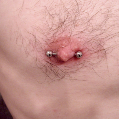 A male nipple piercing with a barbell on a build that used to look like these flat nipples!
