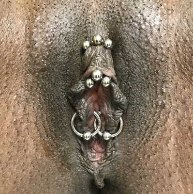 Triad of a VCH in the center and Princess Dianas on the sides of the hood-plus a pair of inner labia piercings